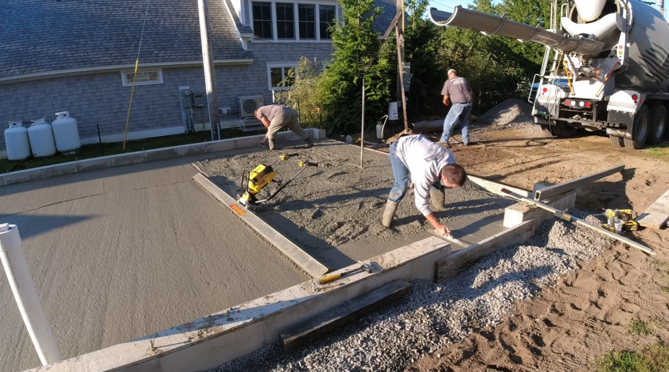 Professional concrete workers finishing a driveway in Meriden, CT